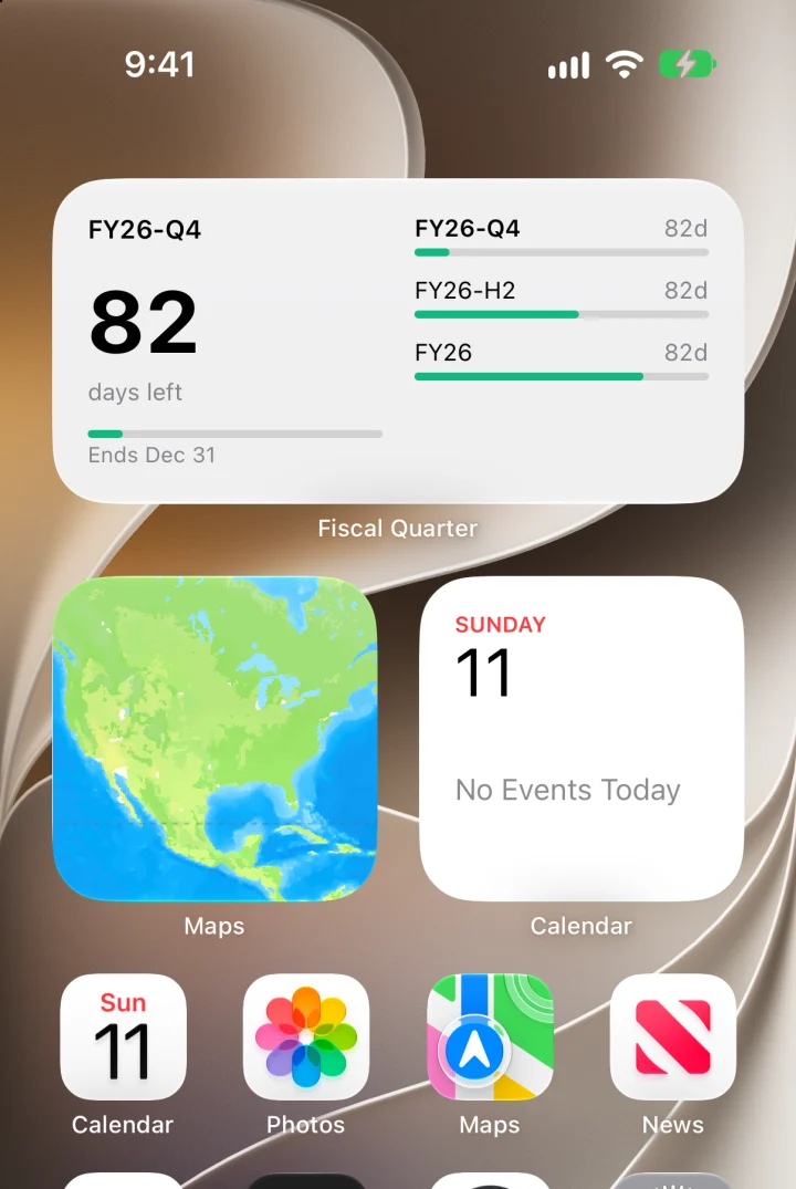 An iPhone Home Screen with a medium Fiscal Quarter widget: FY26-Q4, 82 days left, and bars for the quarter, half, and year.